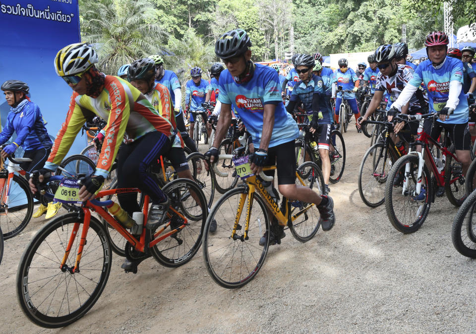 Participants start during a marathon and biking event in Mae Sai, Chiang Rai province, Thailand, Sunday, June 23, 2019. Around 4,000 took part in the event Sunday morning, organized by local authorities to raise funds to improve conditions at the now famous Tham Luang cave complex. The youngsters went in to explore before rain-fed floodwaters pushed them deep inside the dark complex. Their rescue was hailed as nothing short of a miracle. (AP Photo/Sakchai Lalit)