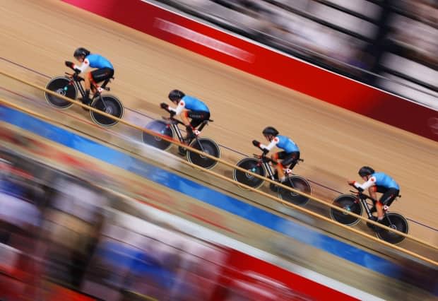 Canada's Jasmin Duehring, left, Allison Beveridge, centre left, Annie Foreman-Mackey, centre right, and Georgia Simmerling, right, sprint during the women's team pursuit of the track cycling competition on Tuesday in Izu, Shizuoka, Japan. (Tim de Waele/Getty Images - image credit)