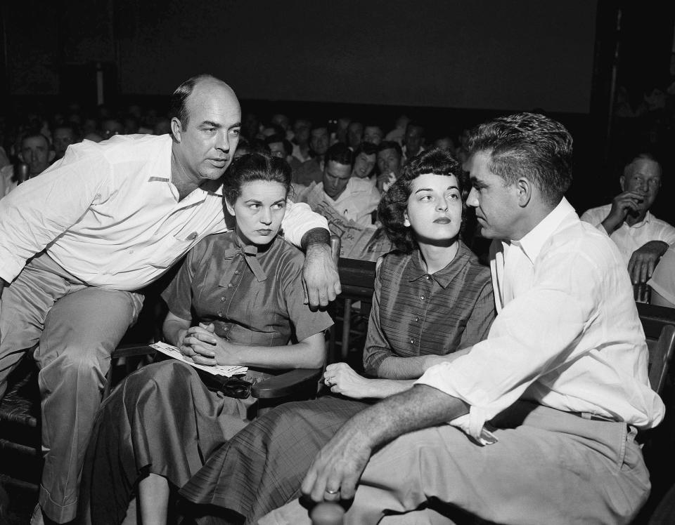 FILE - In this Sept. 23, 1955, file photo, J.W. Milam, left, his wife, second from left, Roy Bryant, far right, and his wife, Carolyn Bryant, sit together in a courtroom in Sumner, Miss. Bryant and his half-brother Milam were charged with murder but acquitted in the kidnapping and torture slaying of 14-year-old black teen Emmett Till in 1955 after he allegedly whistled at Carolyn Bryant. The government is still investigating the brutal slaying of the black teenager that helped spur the civil rights movement more than 60 years ago. A Justice Department report issued to Congress about civil rights cold case investigations lists the killing of Till as being among the unit’s active cases. (AP Photo, File)