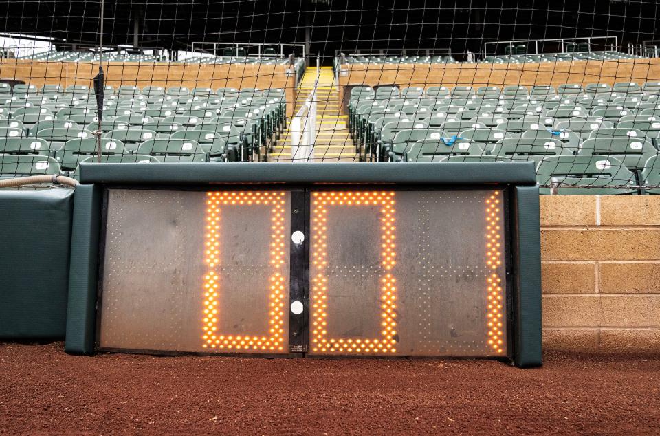 New clocks are installed in behind home plate and the outfield as part of the rule changes for 2023.