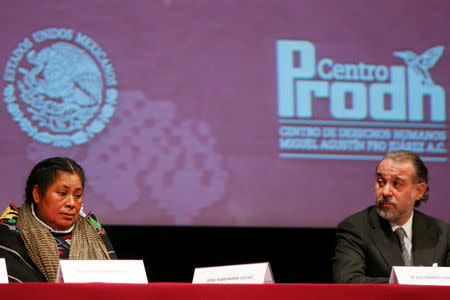 Jacinta Francisco (L), one of three indigenous women who were wrongfully jailed for years, sits next to Attorney General Raul Cervantes during a formal apology from the Attorney General's Office, in Mexico City, Mexico February 21, 2017. REUTERS/Carlos Jasso