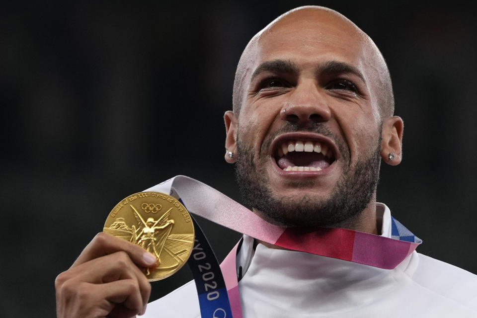 FILE - Lamont Marcell Jacobs, of Italy poses with his gold medal following the men's 100-meters final at the 2020 Summer Olympics, Monday, Aug. 2, 2021, in Tokyo. Track and field is set to become the first sport to introduce prize money at the Olympics, with World Athletics saying Wednesday, April 10, 2024, it would pay $50,000 to gold medalists in Paris. (AP Photo/Francisco Seco, File)