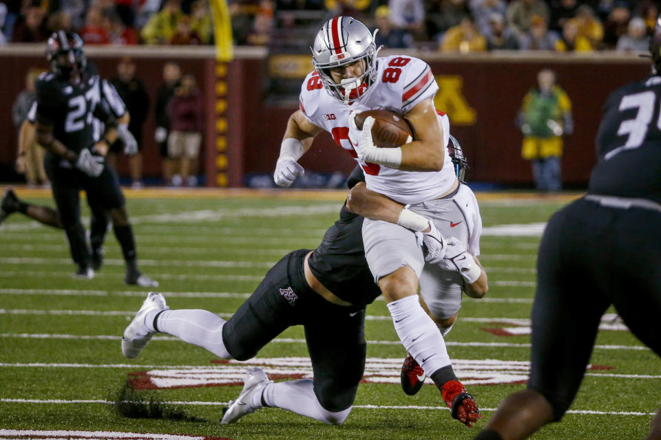 Minnesota linebacker Jack Gibbens tackles Ohio State tight end Jeremy Ruckert (88) during the second quarter of an NCAA college football game Thursday, Sept. 2, 2021, in Minneapolis. Ohio State won 45-31. (AP Photo/Bruce Kluckhohn)