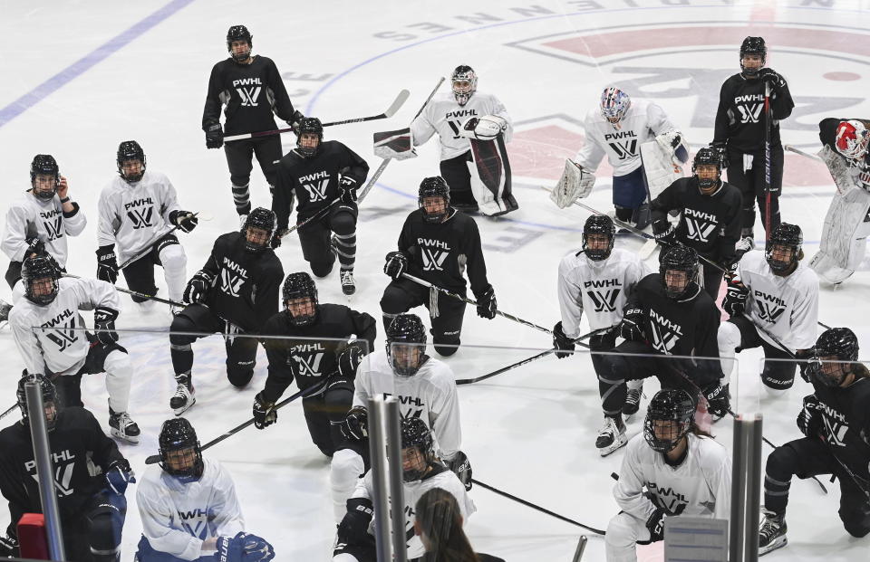 Montreal players listen to head coach Kori Cheverie during the FILE - Professional Women's Hockey League (PWHL) training camp in Montreal, Saturday, Nov. 18, 2023. The long-envisioned dream of having one North American women's hockey league bringing together the world's top players is finally approaching reality. The Professional Women's Hockey League will kick off the new year and its inaugural season on Monday, Jan. 1, 2024 when the yet-to-be named Toronto franchise hosts New York. (Graham Hughes/The Canadian Press via AP)