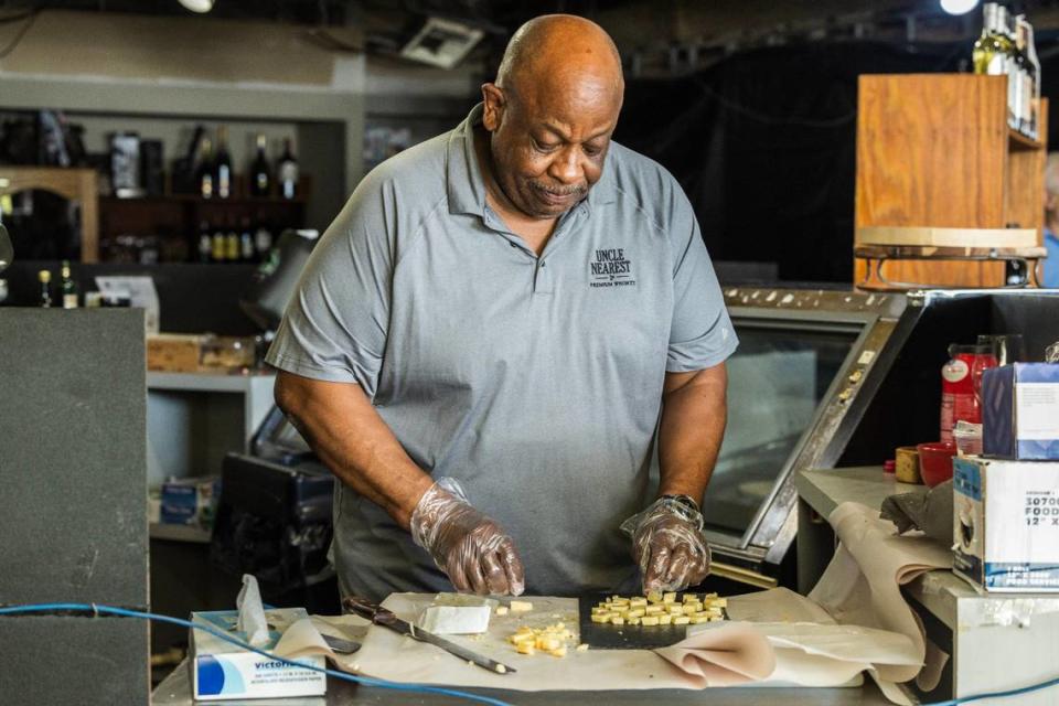 Sunset Corners’ David McGriff prepares the cheeses and hors d’oeuvre for the Saturday, June 1, 2024, wine tasting at the landmark family business at 8701 Sunset Dr., in Miami.