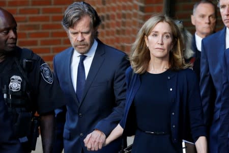 Actress Felicity Huffman and husband William H. Macy leave the federal courthouse in Boston