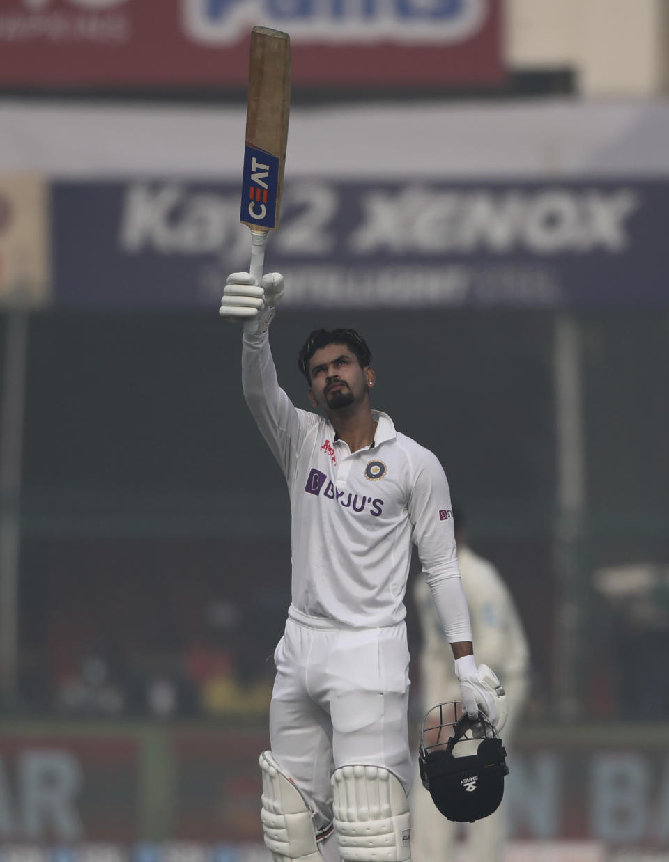 India's Shreyas Iyer raises his bat after scoring a century during the day two of their first test cricket match with New Zealand in Kanpur, India, Friday, Nov. 26, 2021. (AP Photo/Altaf Qadri)