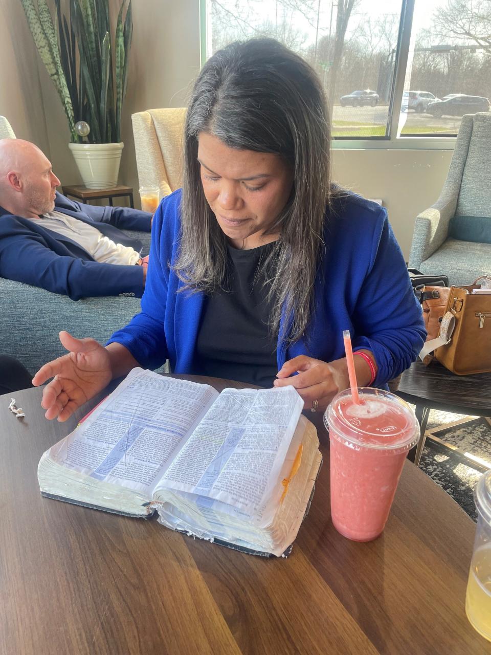 Republican gubernatorial candidate Jamie Reitenour opens her Bible at Command Coffee on March 13, 2024.