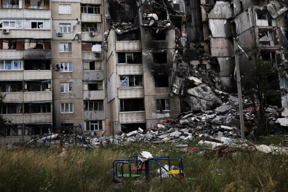 A book is seen on a playground in front of a building destroyed by a military strike, as Russia's invasion of Ukraine continues, in northern Saltivka, in Kharkiv, Ukraine July 13, 2022. REUTERS/Nacho Doce