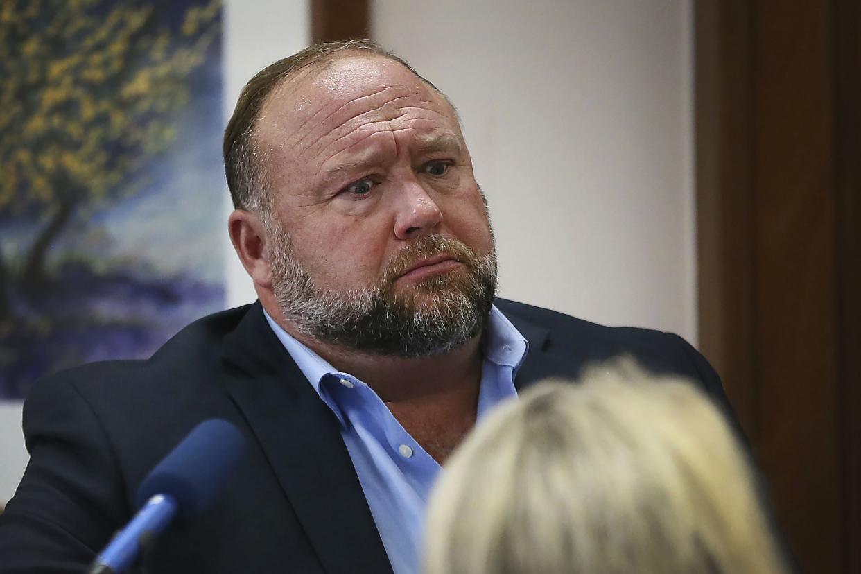 In this Aug 3, 2022 photo, conspiracy theorist Alex Jones attempts to answer questions about his emails during trial at the Travis County Courthouse in Austin. 
