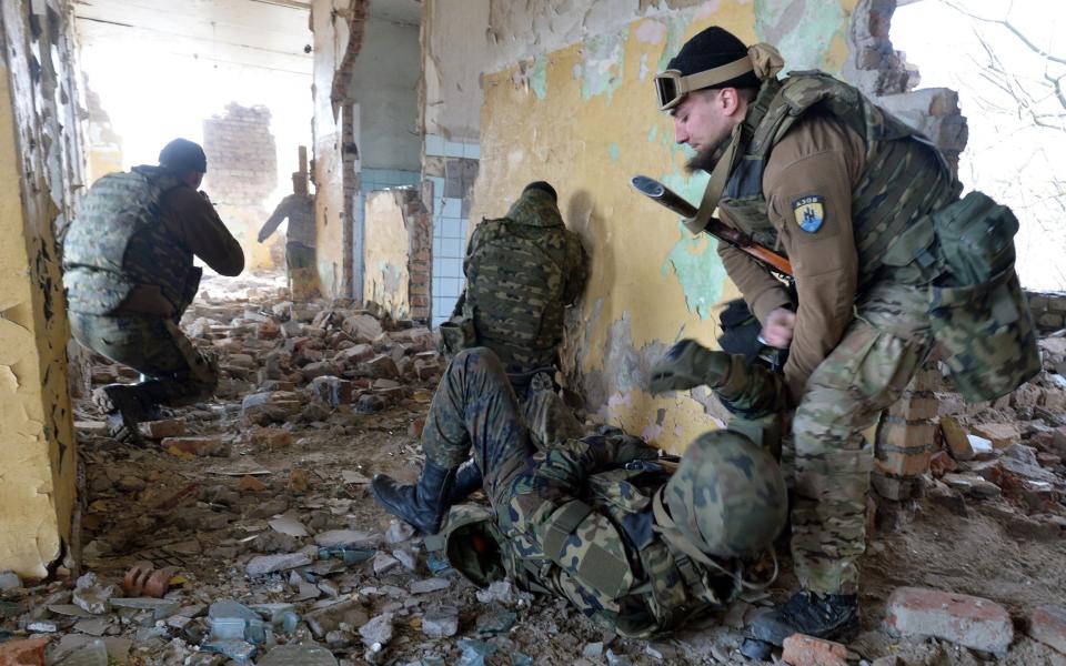 Ukrainian volunteers take part in military exercises near Mariupol  - Genya Savilov/AFP