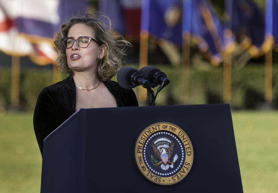 Sen. Kyrsten Sinema, D-Ariz., delivers remarks before the signing ceremony on Monday.