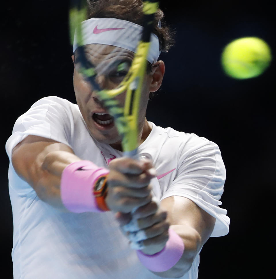 Spain's Rafael Nadal plays a return to Stefanos Tsitsipas of Greece during their ATP World Tours Finals singles tennis match at the O2 Arena in London, Friday, Nov. 15, 2019. (AP Photo/Alastair Grant)