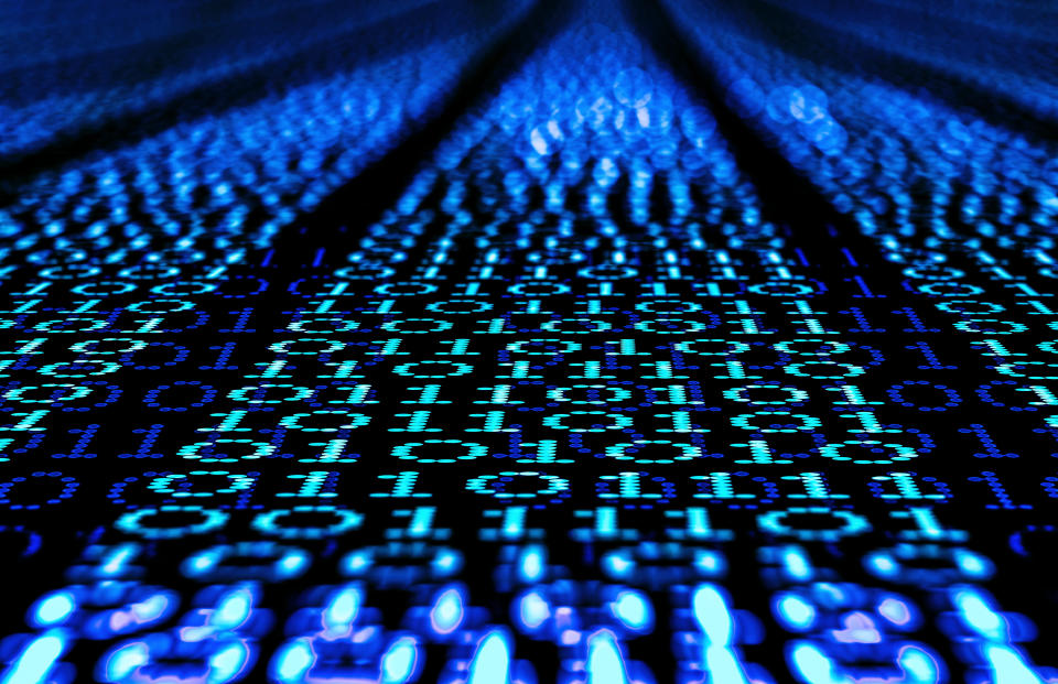 Binary code, ones and zeros in a 1970 dot matrix font on a computer screen. An infinity and lens bokeh effect applied.