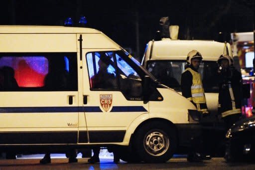 French police vehicles secure the perimeter of a siege on an apartment block where Mohamed Merah, the man suspected of a series of deadly shootings, was holed up in Toulouse, southwestern France. French police stepped up pressure Thursday on the besieged Al-Qaeda militant who boasted of having "brought France to its knees" with a wave of brutal attacks that left seven dead