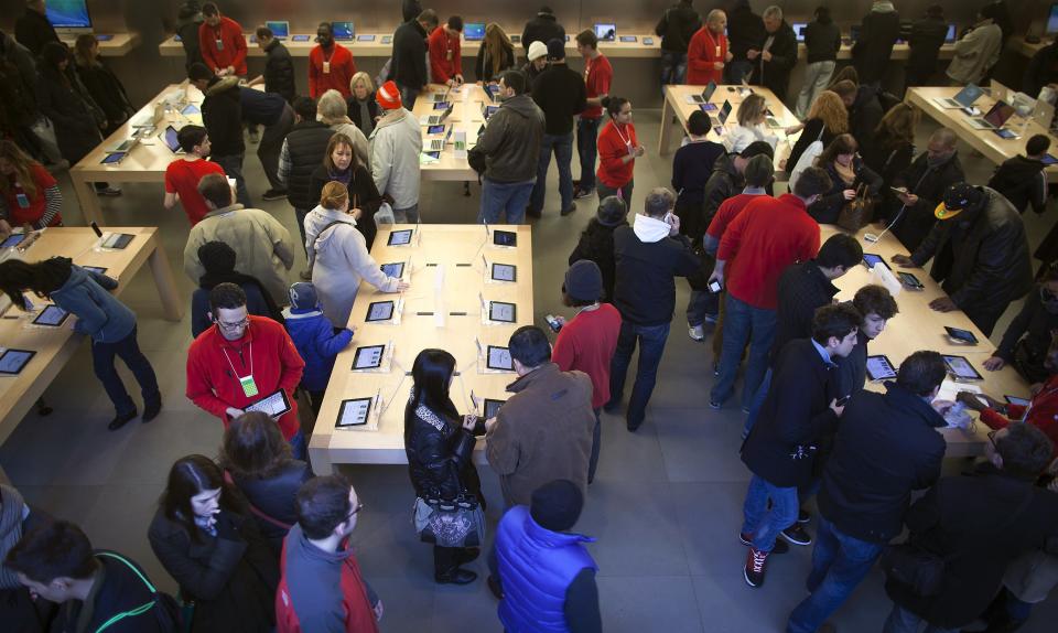 Shoppers are pictured inside an Apple store on 5th Ave during Black Friday Sales in New York