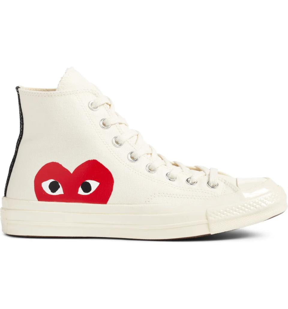 White Comme des Garçons sneaker with red heart on this side