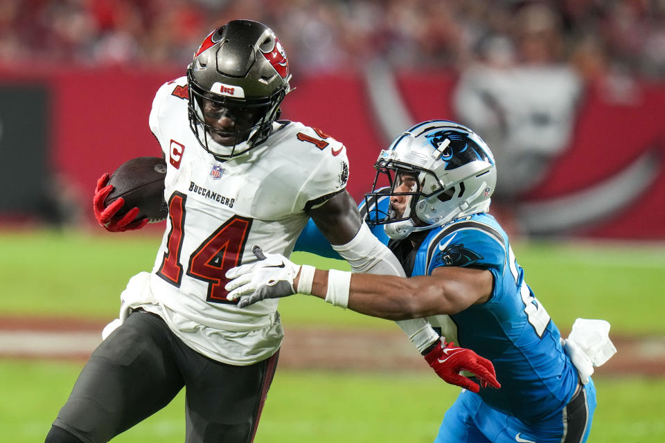 Tampa Bay Buccaneers wide receiver Chris Godwin runs for a touchdown past Carolina Panthers safety Alex Cook during the second half of an NFL football game Sunday, Dec. 3, 2023, in Tampa, Fla. (AP Photo/Chris O'Meara)