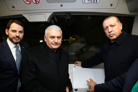 Turkish President Tayyip Erdogan poses with Prime Minister Binali Yildirim and Energy Minister Berat Albayrak in a train during an opening ceremony of a new metro line in Istanbul, Turkey December 15, 2017. Kayhan Ozer/Presidential Palace/Handout via REUTERS