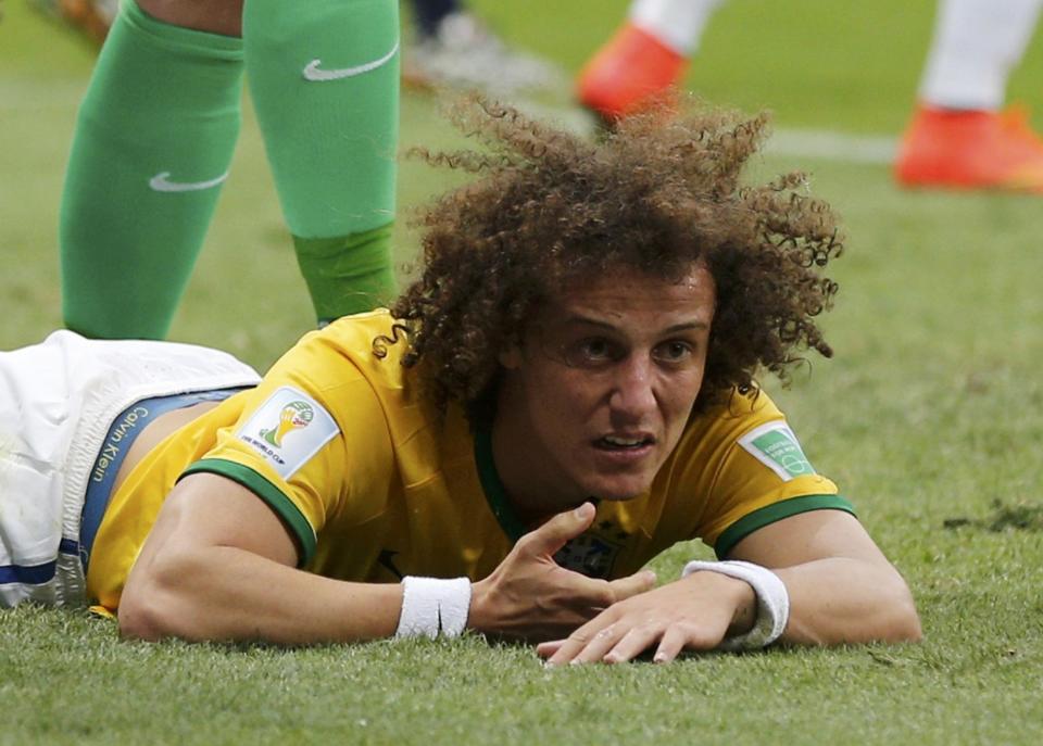 Brazil's David Luiz lies on the pitch after missing a goal during the 2014 World Cup third-place playoff between Brazil and the Netherlands at the Brasilia national stadium in Brasilia July 12, 2014. REUTERS/Ueslei Marcelino (BRAZIL - Tags: TPX IMAGES OF THE DAY SOCCER SPORT WORLD CUP)