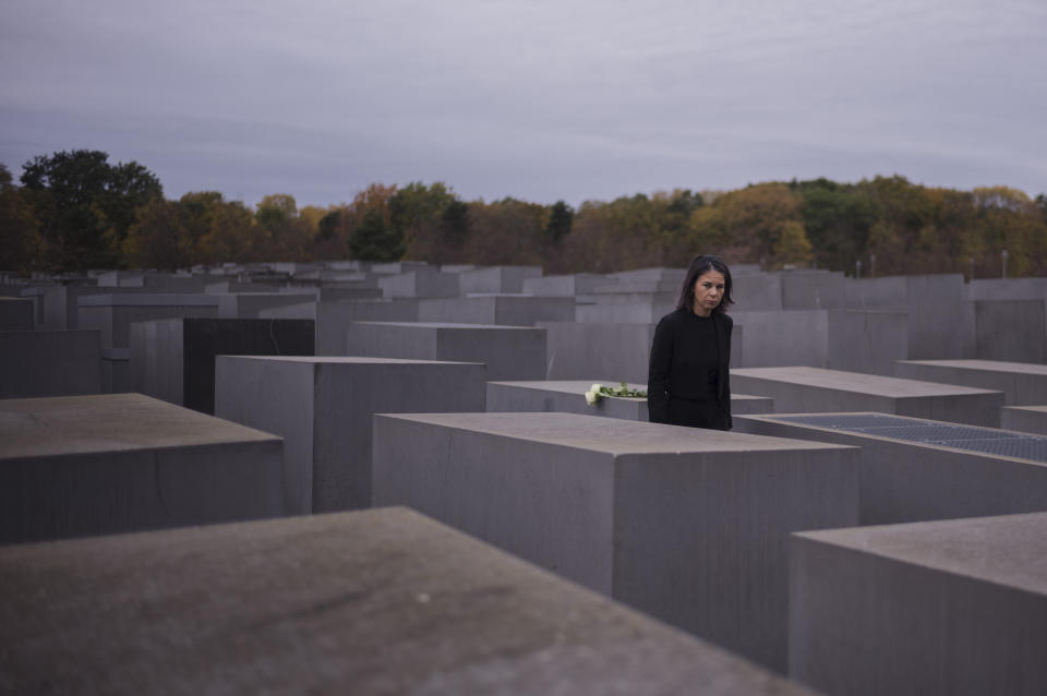 German Foreign Minister Annalena Baerbock places flowers at The Memorial to the Murdered Jews of Europe, known as Holocaust Memorial to commemorate on the 85th anniversary of the November 1938 progroms in Germany and Austria, in central Berlin, Germany, Thursday, Nov. 9, 2023. According to Israel's Yad Vashem Holocaust memorial, the Nazis killed at least 91 people, vandalized 7,500 Jewish businesses and burned more than 1,400 synagogues during Nov. 9, 1938 pogroms known as Kristallnacht or 'Night of broken Glass',. (AP Photo/Markus Schreiber)