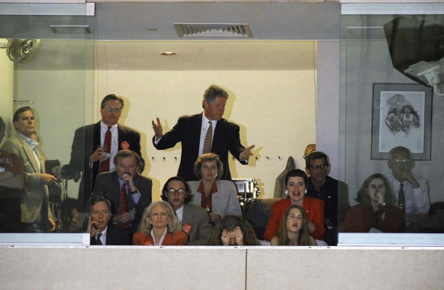 Pres. Bill Clinton, center, reacts during Arkansas semifinal game of Final Four with Arizona, Saturday, April 2, 1994, Charlotte, N.C. Arkansas advances to Mondays final with a 91-82 victory. The rest of the group is unidentified. (AP Photo/J. Scott Applewhite)