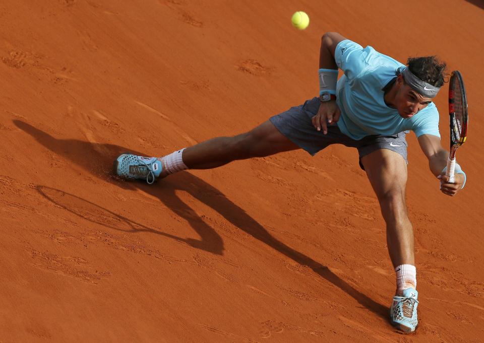 Rafael Nadal of Spain returns the ball to Novak Djokovic of Serbia during their men's singles final match at the French Open Tennis tournament at the Roland Garros stadium in Paris June 8, 2014. REUTERS/Gonzalo Fuentes (FRANCE - Tags: SPORT TENNIS)