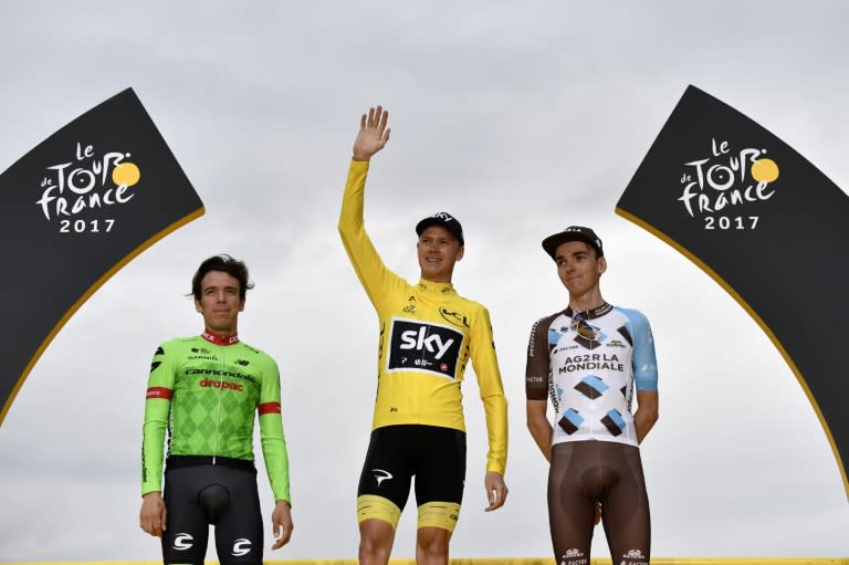 Colombia's Rigoberto Uran (L), Great Britain's Christopher Froome (C) and France's Romain Bardet celebrate on the podium on the Champs-Elysees avenue in Paris on July 23, 2017