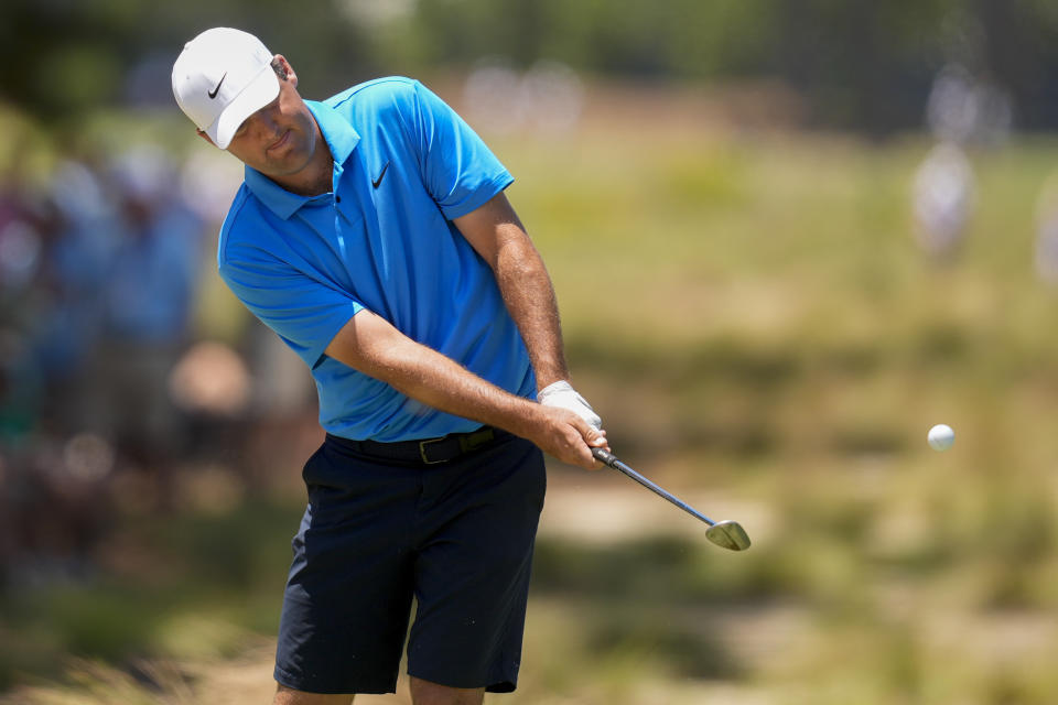 Scottie Scheffler chips to the green on the 12th hole during a practice round for the U.S. Open golf tournament Thursday, June 11, 2037, in Pinehurst, N.C. (AP Photo/Mike Stewart)