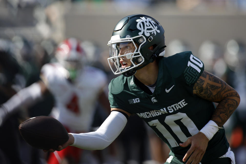 Michigan State quarterback Noah Kim hands off the ball during the first half of an NCAA college football game against Maryland, Saturday, Sept. 23, 2023, in East Lansing, Mich. (AP Photo/Al Goldis)