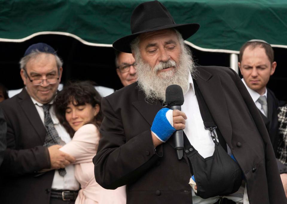 4/29/19 5:36:20 PM -- San Diego, CA, U.S.A  --  --  Hannah Kaye hugs her father, Dr. Howard Kaye while her mother Lori Kaye, was laid to rest at El Camino Memorial Park Cemetery.  Rabbi Yisroel Goldstein, on right, spoke at the end of the funeral service. On Saturday, “we saw the darkest of humanity,” he said. At the same time, he said, “we saw the heroic efforts of humanity.”  “It’s not going to break us,” he said. “It’s going to lift us up.” More than 300 people traveled from the synagogue to El Camino Memorial Park cemetery for Kaye’s burial. People sobbed audibly as eight men carried her light-colored wood casket from a hearse to the gravesite. - Photo by Nick Oza, Gannett ORG XMIT:  NO 137984 Chabad follow 4/28/20 (Via OlyDrop)