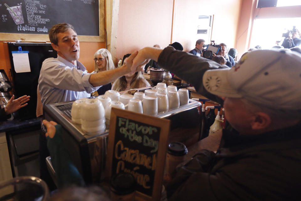 Former Texas congressman Beto O'Rourke greets an audience member during a stop at the Central Park Coffee Company, Friday, March 15, 2019, in Mount Pleasant, Iowa. O'Rourke announced Thursday that he'll seek the 2020 Democratic presidential nomination. (AP Photo/Charlie Neibergall)