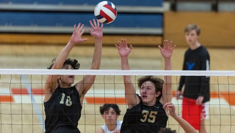 Maple Mountain Golden Eagles middle blocker Manase Storey (18) and outside hitter Mac Hillman (35) jump during a match at Timpview High School in Provo on Thursday, April 18, 2024.