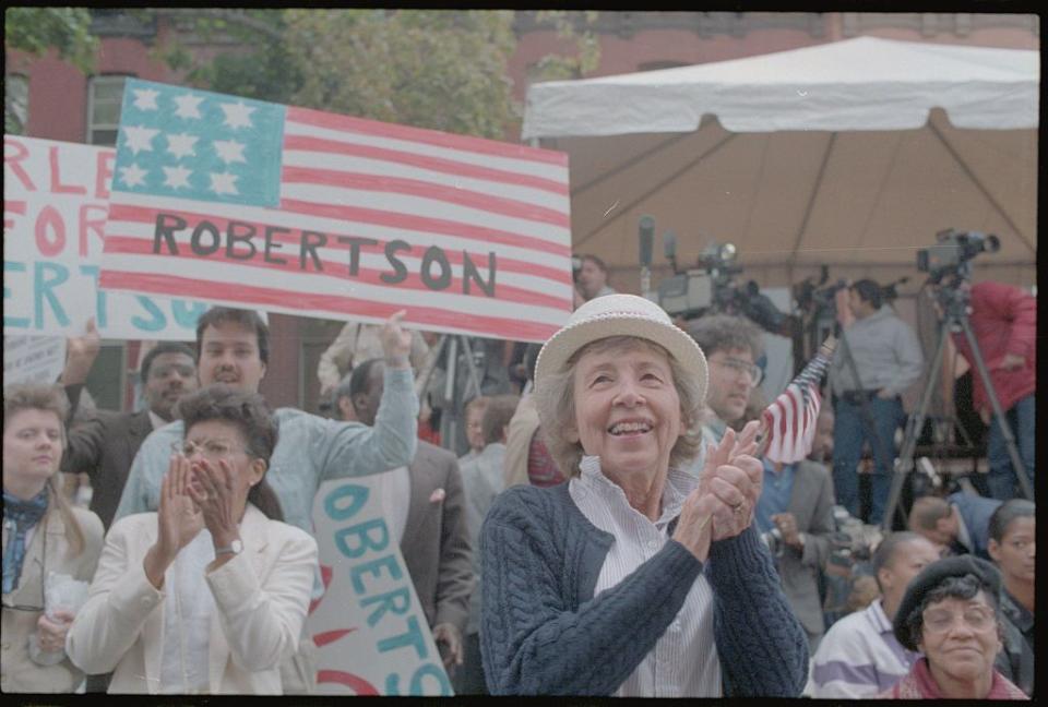 pat robertson supporters with flag and banners