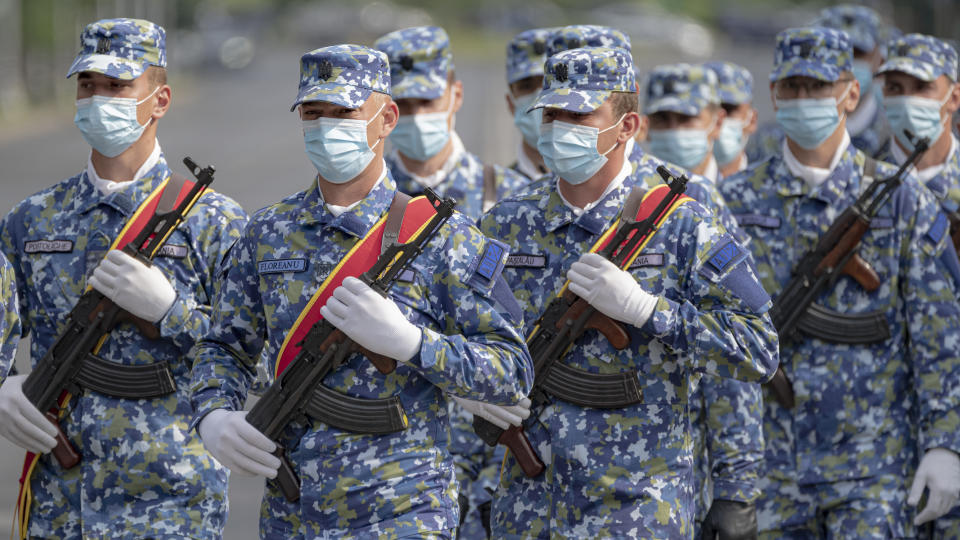 Members of an air defense unit get their uniforms marchbefore a ceremony for Aviation Day which celebrates aviators, military and civilian, who lost their lives in the line of duty or contributed to the evolution of Romanian aviation. in Bucharest, Romania, Tuesday, July 20, 2021. The traditional flyover by military aircraft was cancelled after a US Air Force Sikorsky UH-60 Black Hawk helicopter experienced technical issues and had to make an emergency landing on a busy boulevard last week while taking part in rehearsals for Aviation Day. (AP Photo/Vadim Ghirda)