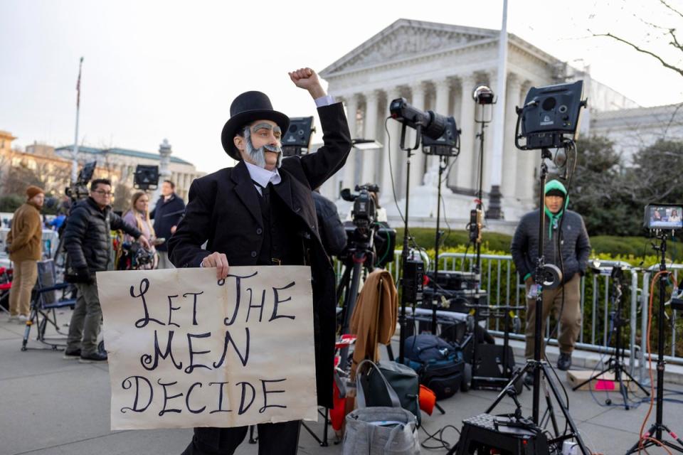 Molly Gaebe of the Abortion Access Front protests outside the US Supreme Court on 26 March dressed as 19th century anti-vice crusader Anthony Comstock. (AP)