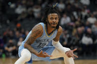 Memphis Grizzlies guard Ja Morant (12) reacts after scoring against the San Antonio Spurs during the second half of an NBA basketball game, Wednesday, Jan. 26, 2022, in San Antonio. (AP Photo/Eric Gay)