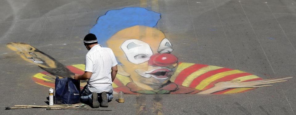 Truman Adams, of Sarasota works on his 3D pavement project during the Sarasota Chalk Festival Wednesday, Oct. 31, 2012, in Sarasota, Fla. The annual festival begins this week and runs through Nov. 6.(AP Photo/Chris O'Meara)