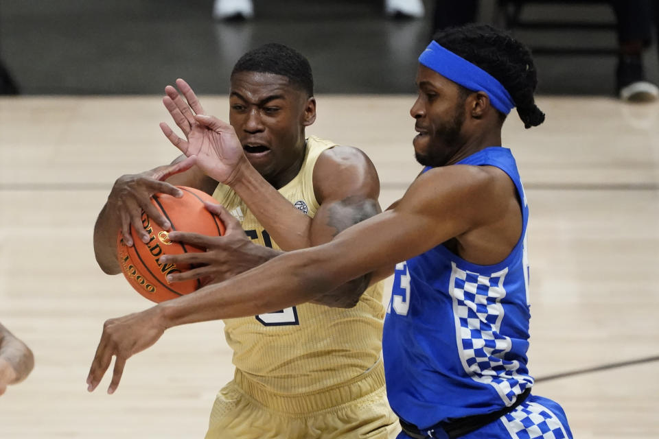 Georgia Tech forward Moses Wright, left, and Kentucky forward Isaiah Jackson, right, battle for control of the ball during the first half of an NCAA college basketball game Sunday, Dec. 6, 2020, in Atlanta. (AP Photo/John Bazemore)