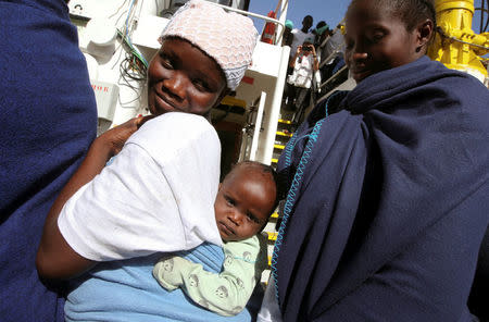 Migrants wait to disembark from the MV Aquarius rescue ship, after being rescued by SOS Mediterranee organisation, in the Sicilian harbour of Trapani, Italy, September 16, 2017. REUTERS/Tony Gentile