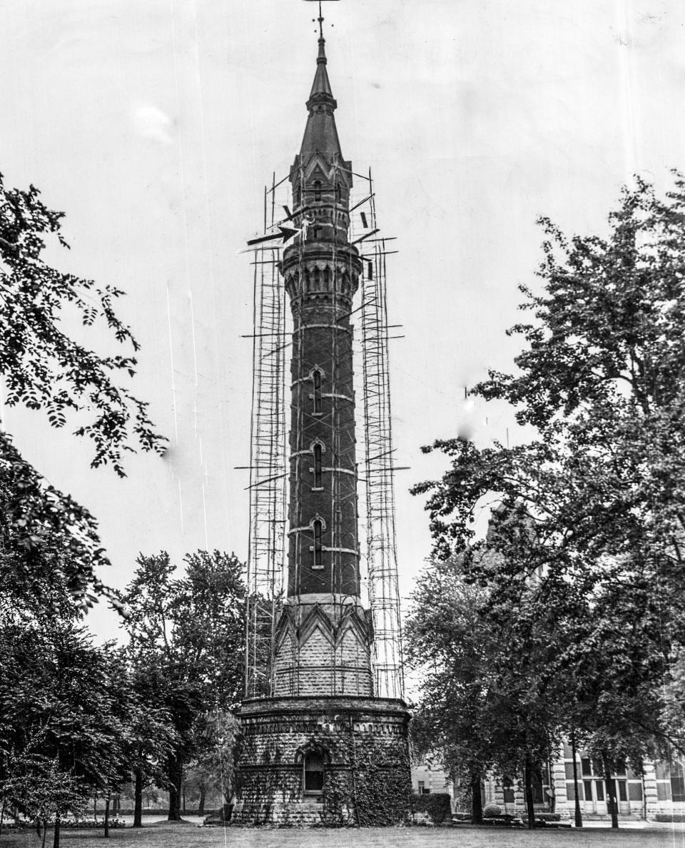 One of the park's most popular features was a 185-foot standpipe tower and observation deck whose panoramic views of the city thrilled Detroiters. An arrow points to a man building scaffolding around the tower as the city prepared to raze it.