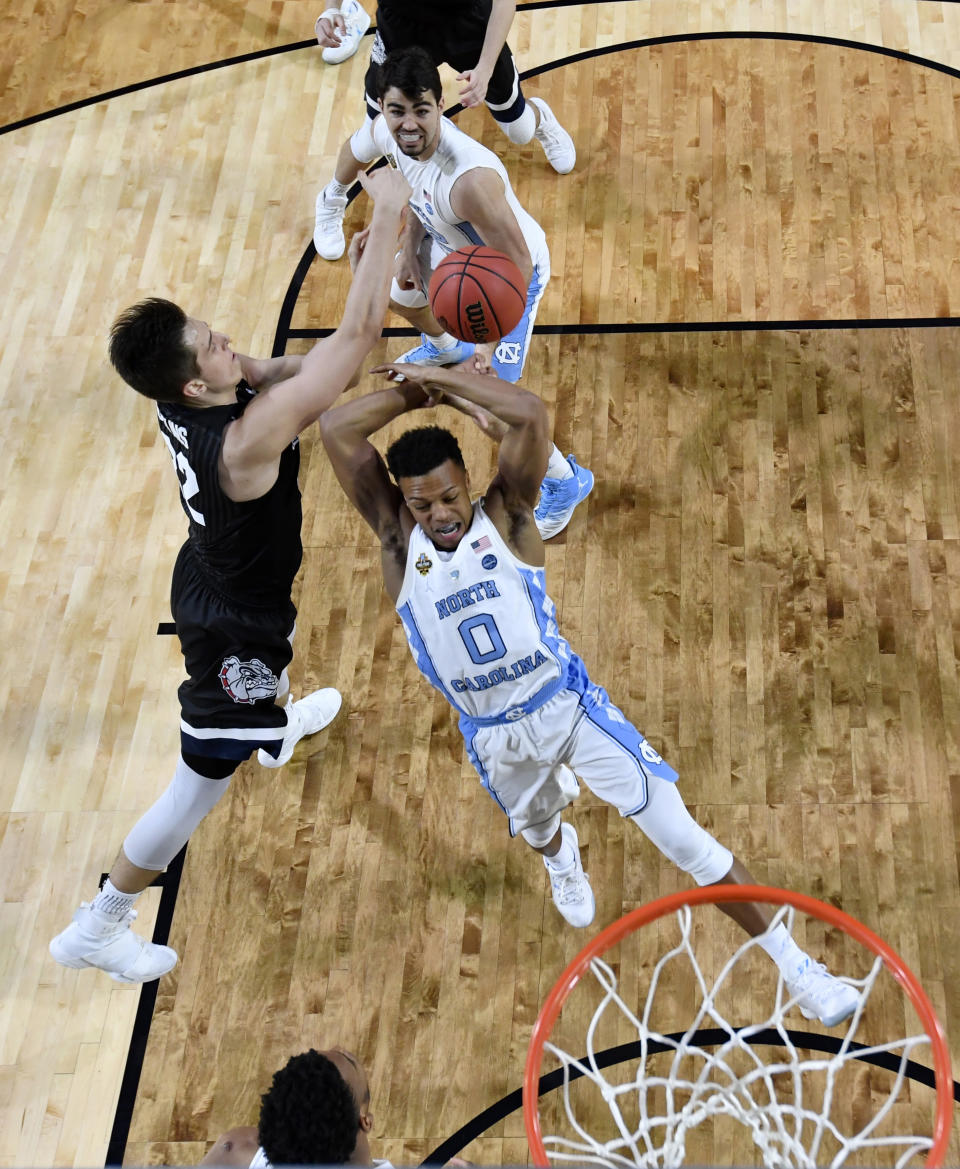 Gonzaga's Zach Collins blocks a shot by North Carolina's Nate Britt (0) during the first half in the finals of the Final Four NCAA college basketball tournament, Monday, April 3, 2017, in Glendale, Ariz. (AP Photo/Chris Steppig, Pool)