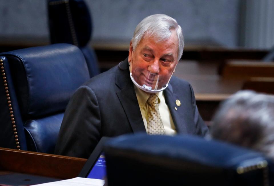 Sen. Jim Tomes speaks to a colleague during the Indiana Senate session Tuesday, Jan. 26, 2021 at the Indiana Statehouse in downtown Indianapolis.