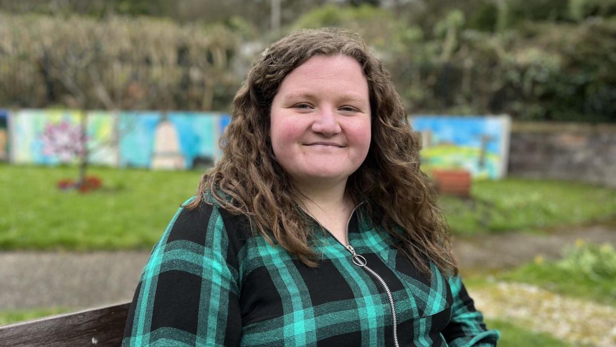 Hannah Carrington, 30, was diagnosed with autism only 18 months ago, sitting on a bench in a garden