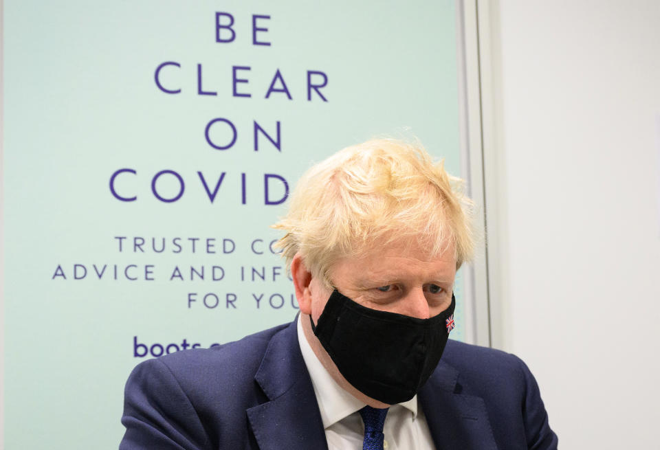UXBRIDGE, ENGLAND - JANUARY 10: Britain&#39;s Prime Minister Boris Johnson prepares to watch a man receive his Covid-19 booster jab as he makes a constituency visit to a Boots pharmacy on January 10, 2022 in Uxbridge, England. (Photo by Leon Neal/Getty Images)