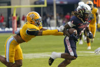 Jackson State wide receiver Dallas Daniels (4) runs through a tackle attempt by Southern University defensive back Jordan Carter (7) during the first half of the Southwestern Athletic Conference championship NCAA college football game Saturday, Dec. 3, 2022, in Jackson, Miss. (AP Photo/Rogelio V. Solis)