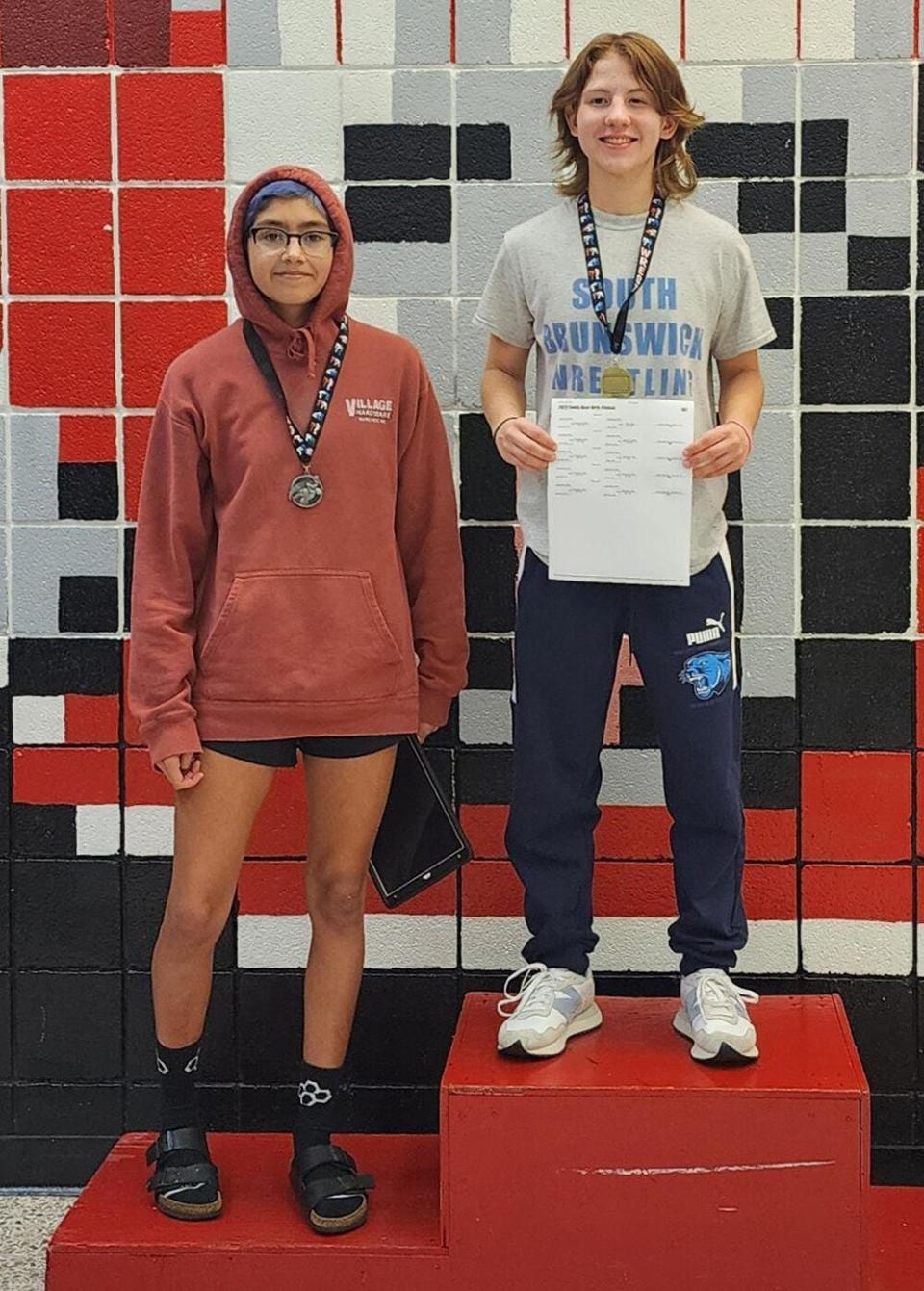 Lilly Prendergast (right) poses after winning the Swiss Bear Girls Classic wrestling tournament in December.