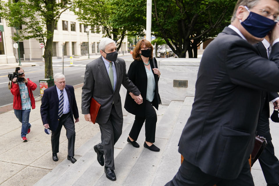 Former Penn State President Graham Spanier, center, arrives for a hearing at the Dauphin County Courthouse in Harrisburg, Pa., Wednesday, May 26, 2021. A judge will determine if and when Spanier must report to jail to begin serving time for a single misdemeanor conviction of endangering the welfare of children. (AP Photo/Matt Rourke)