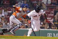 Boston Red Sox's Jackie Bradley Jr., right, tries to run to first after hitting an infield grounder as Houston Astros' Jason Castro, left, runs to field the ball in the seventh inning of a baseball game, Monday, May 16, 2022, in Boston. Bradley Jr. was out on the play. (AP Photo/Steven Senne)