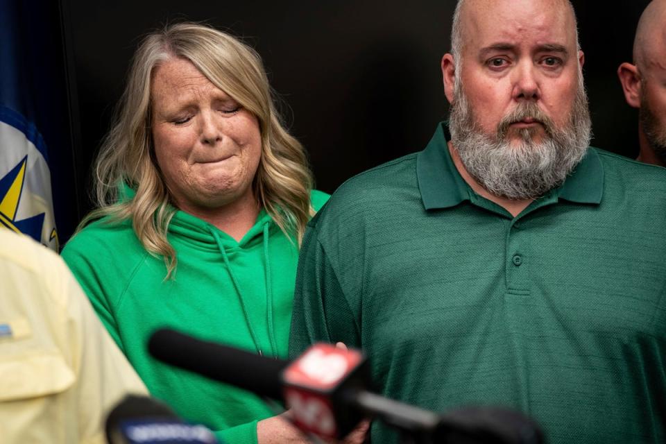 Michelle Strain Whiteid, left, mother of Riley Strain, holds on to the arm of her husband, Chris Whiteid, during a news conference at the Metro Nashville Police Department headquarters in Nashville (AP)